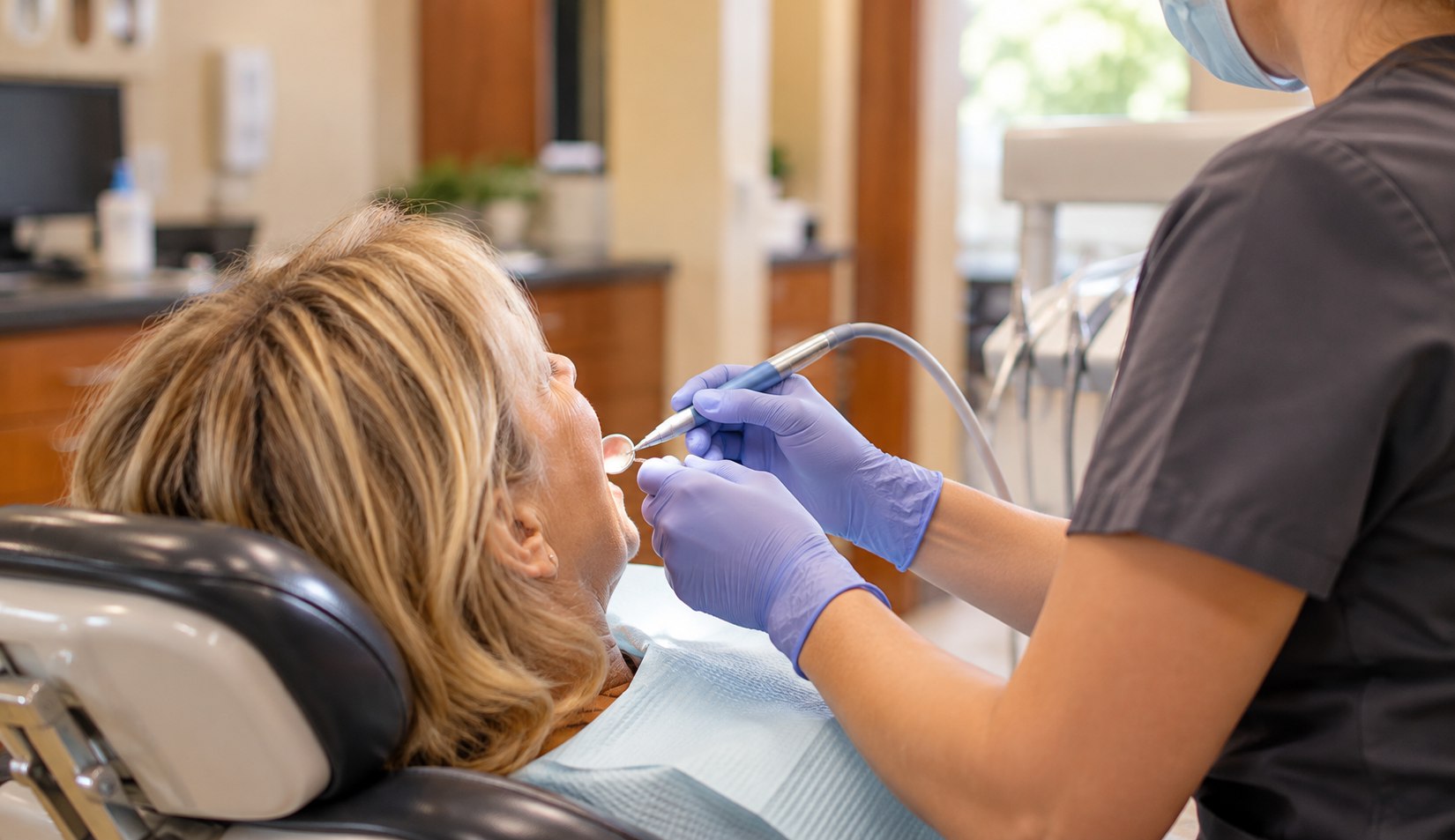 Illustrative concept image of a patient receiving a dental cleaning